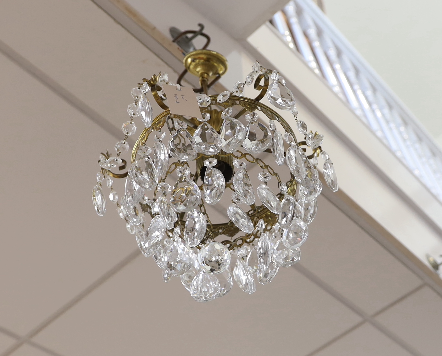 A gilt metal and cut glass ceiling shade hung faceted drops, height 42cm
